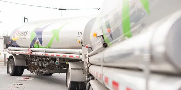 Fuel tanker viewed from the side without front on an overcast day.